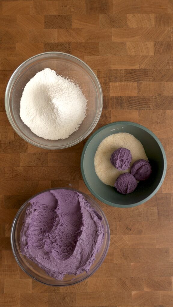 Rolling cookie dough in granulated sugar